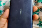 Nokia C1 smartphone with earbuds